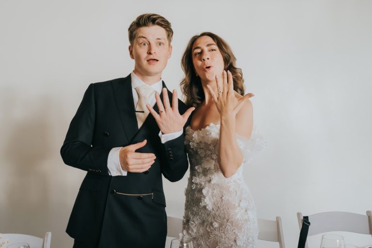 Bride and groom showing their rings