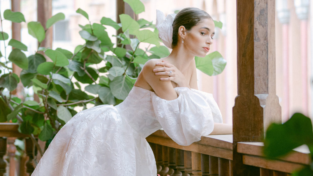 Bride wearing an off-the-shoulder wedding dress with statement sleeves