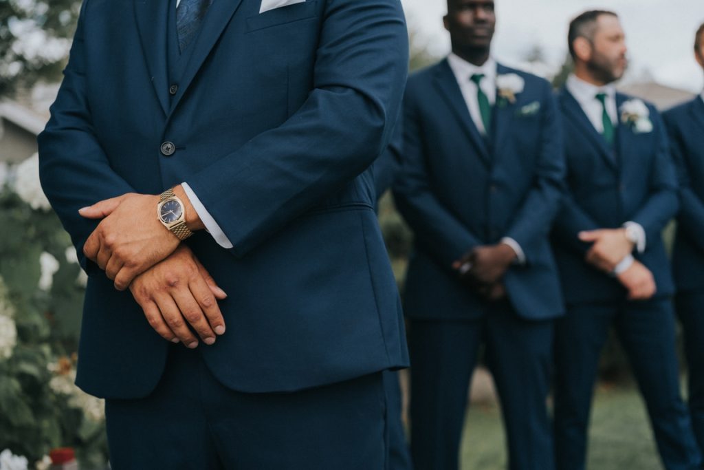 Groomsmen wearing blue suits with white boutonnieres