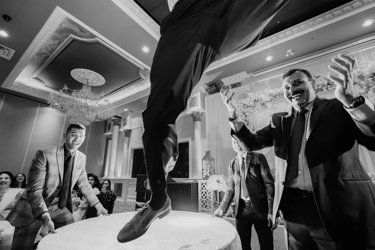 Black-and-white photograph of wedding guests dancing