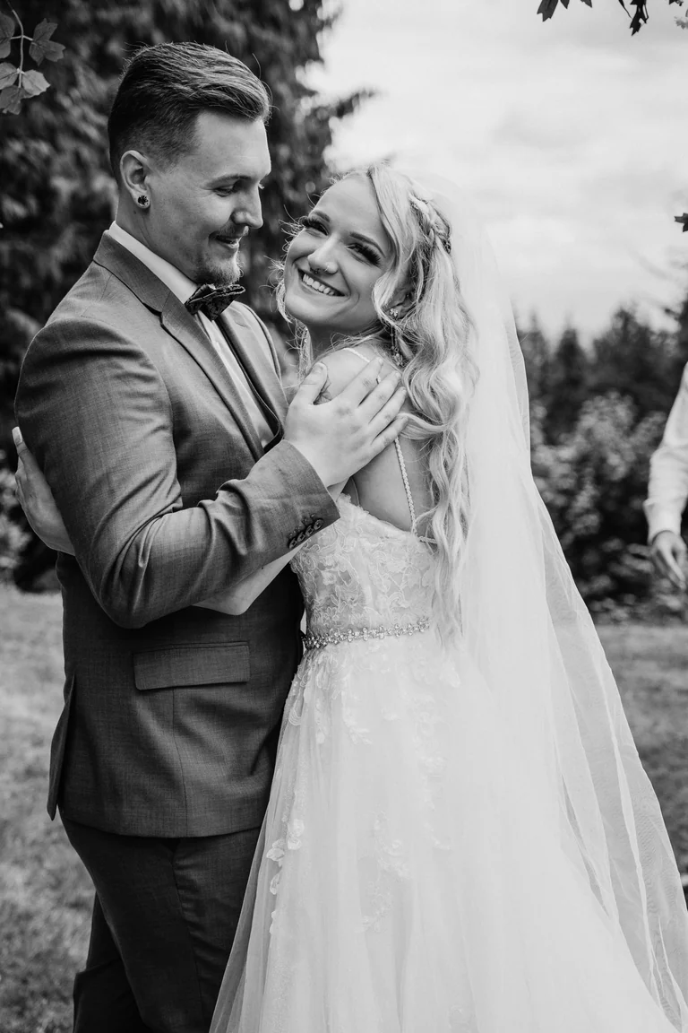 Black-and-white wedding portrait of newlyweds embracing