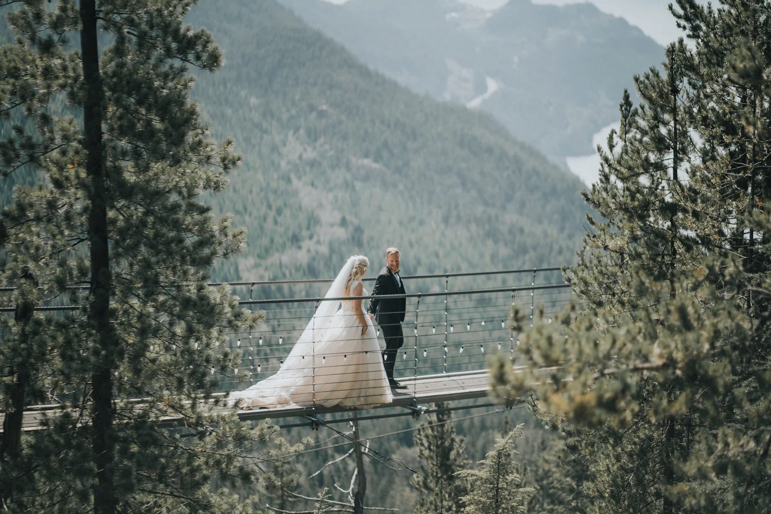 Bride and groom beside a mountain lake