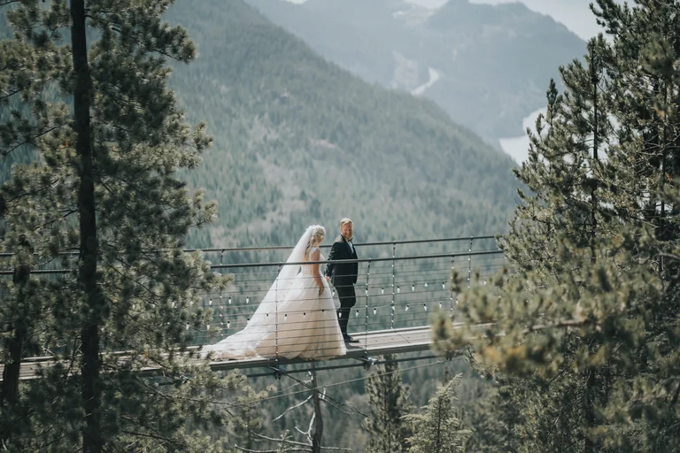 Bride and groom beside a mountain lake
