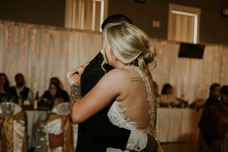 Bride and groom embracing at the reception