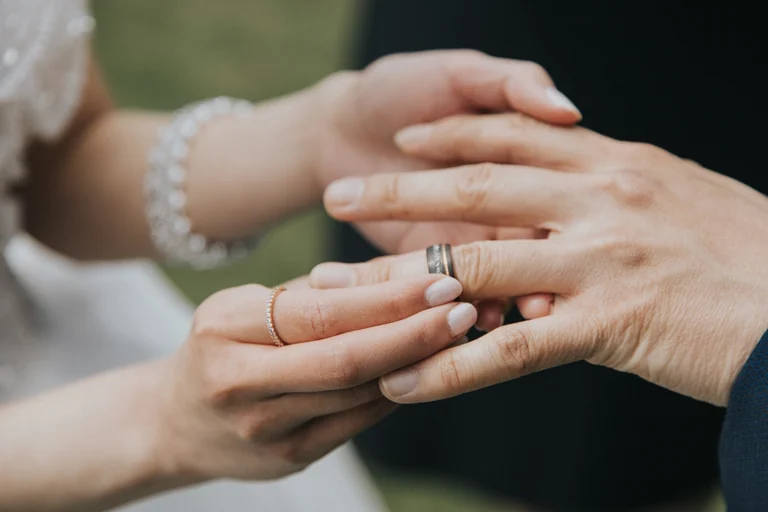 Bride and groom exchanging wedding rings