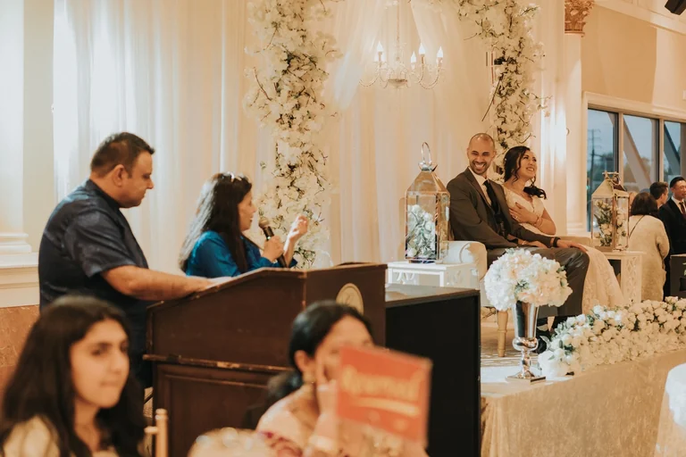 Bride and groom listening during a family ceremony