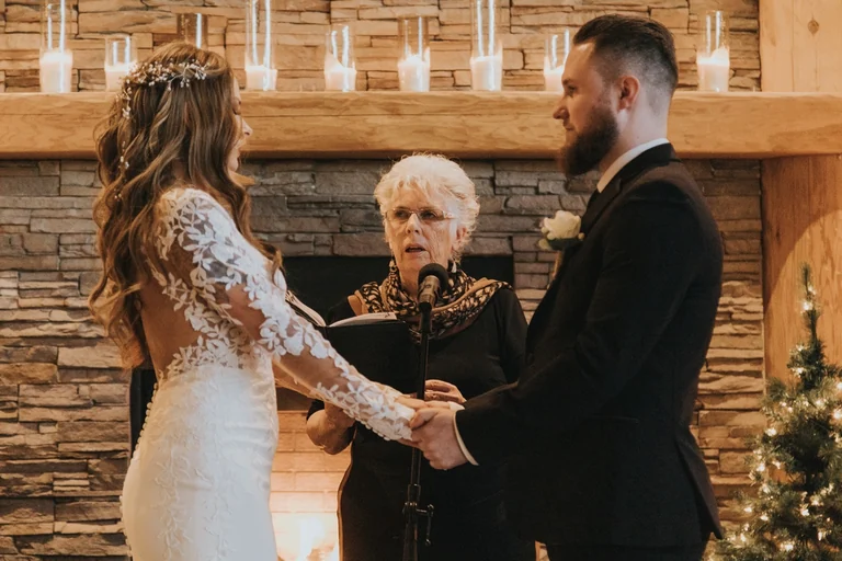 Bride and groom listening to the wedding officiant