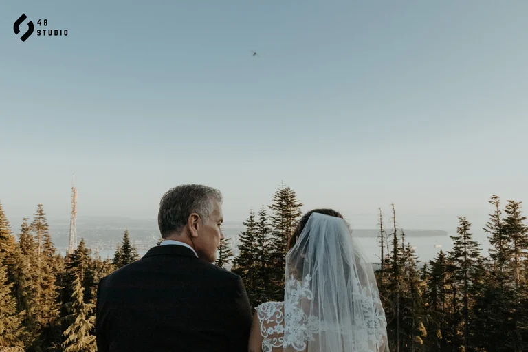 Bride and groom looking toward the sunset