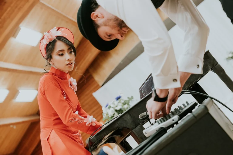 Bride and groom playing a keyboard together