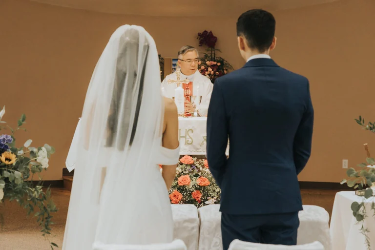 Bride and groom standing before the ceremony altar