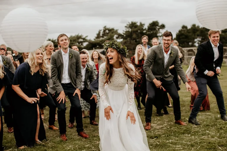 Bride celebrating outdoors with friends