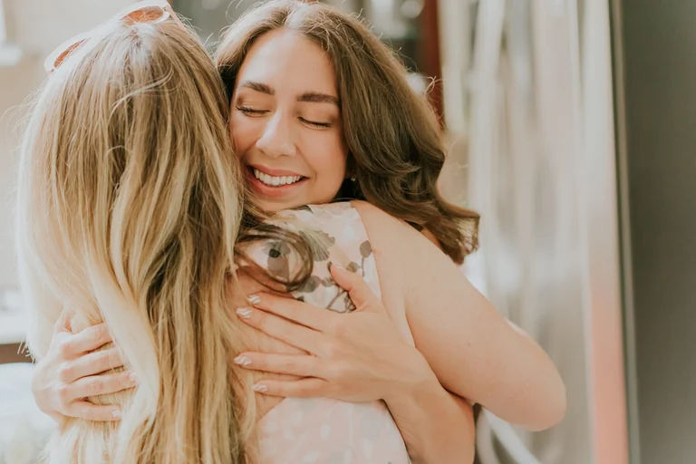 Bride embracing a wedding guest