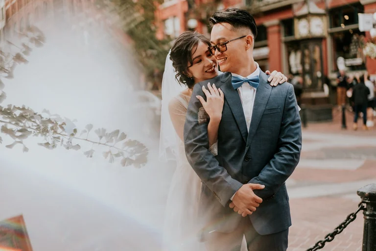 Bride embracing the groom from behind