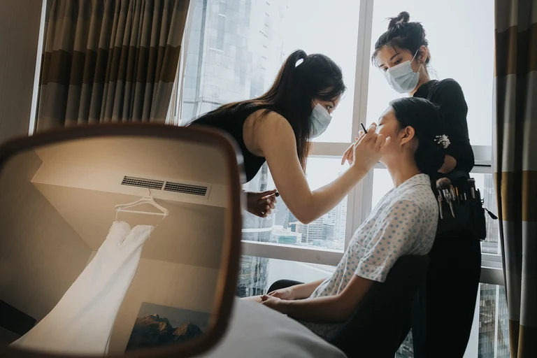 Bride having her makeup applied before the wedding