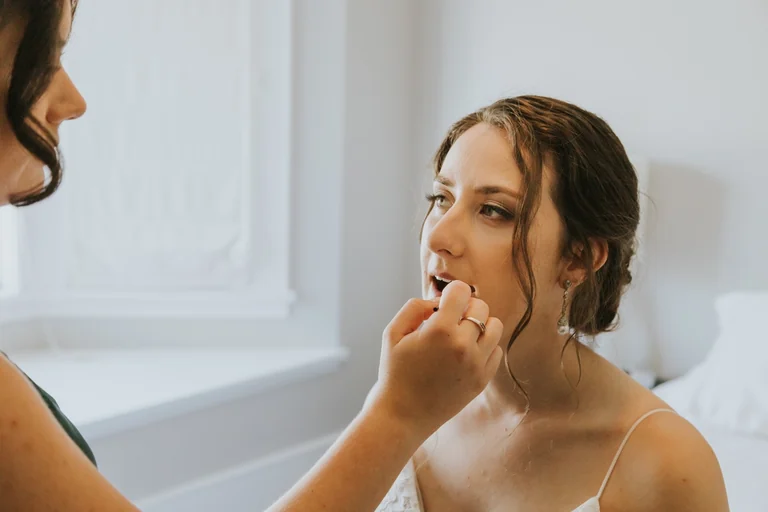 Bride having her makeup finished