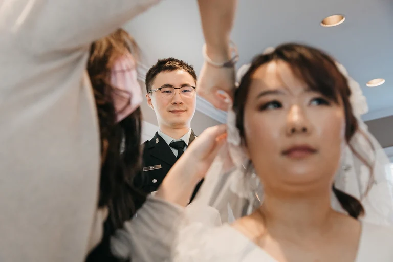Bride having her veil arranged