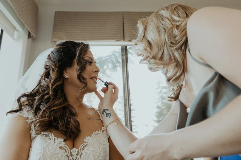 Bride having makeup applied before the wedding