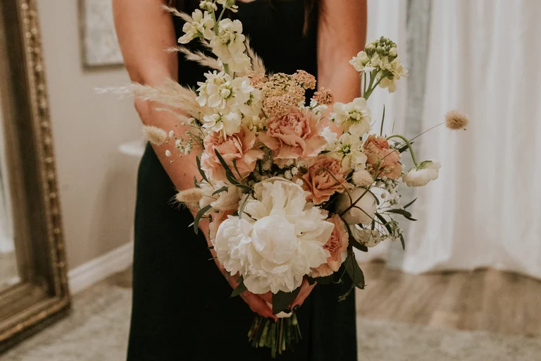 Bride holding a pastel wedding bouquet