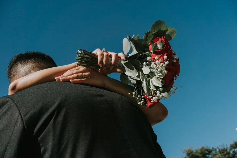 Bride holding red wedding flowers