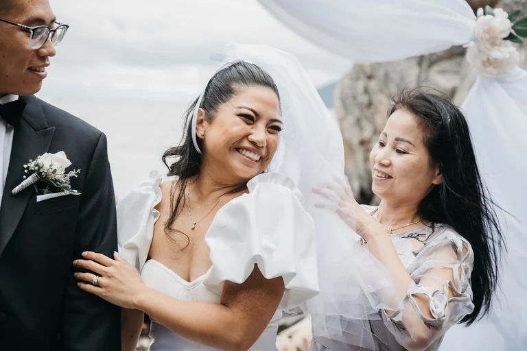 Bride smiling beside a wedding guest
