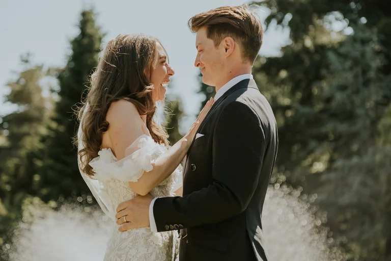 Bride touching the groom's face during their vows