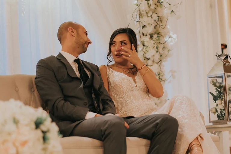 Bride wiping a tear beside the groom