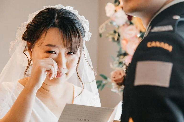 Bride wiping a tear with a tissue