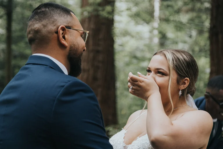 Bride wiping tears during the first look