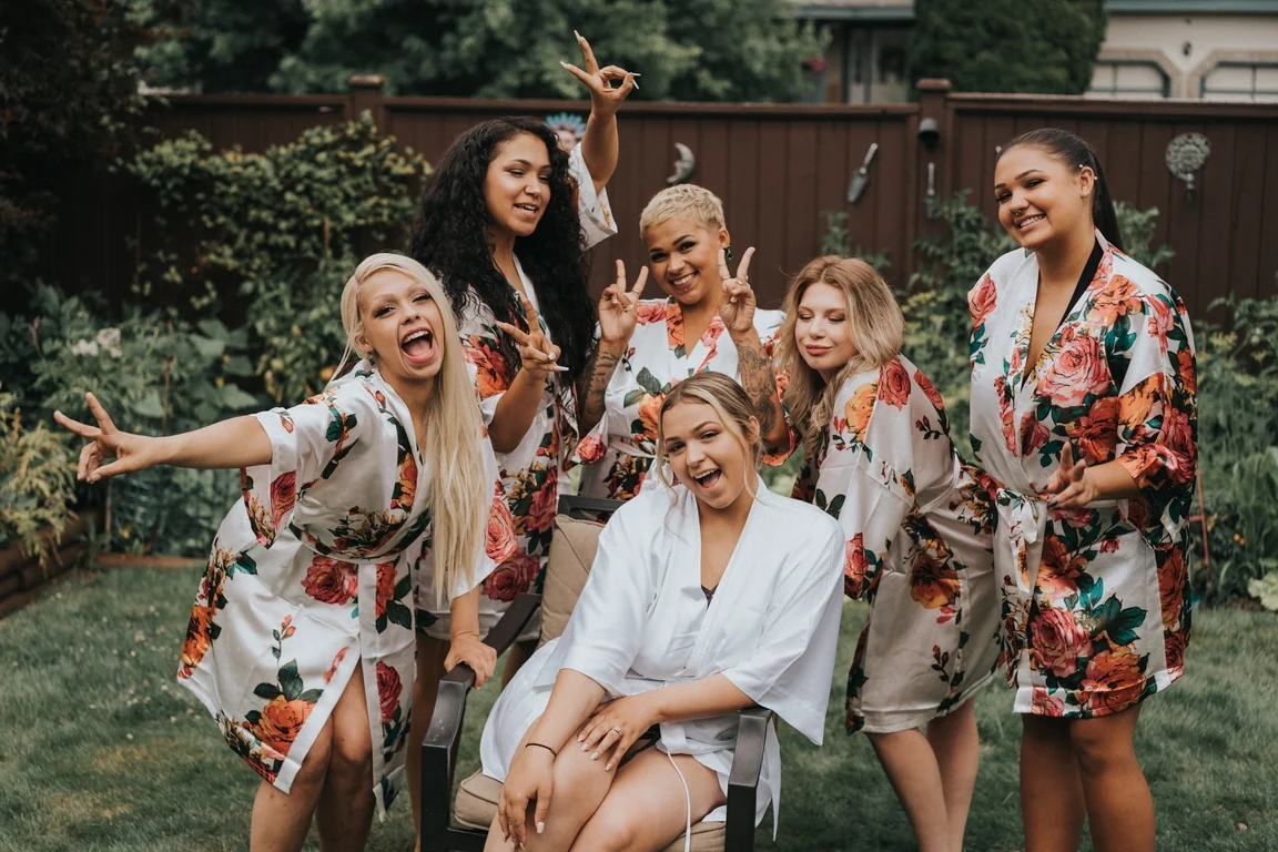 Bridesmaids celebrating with the bride outdoors
