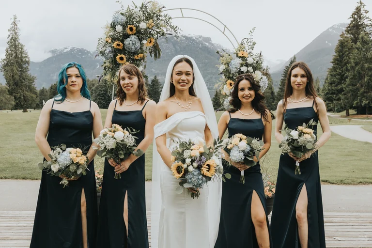 Bridesmaids holding bouquets beside the bride