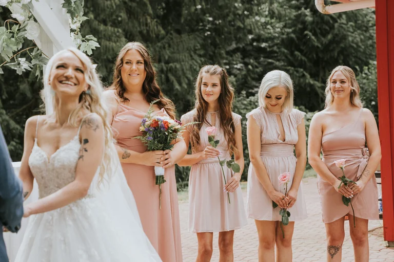 Bridesmaids standing together with flowers