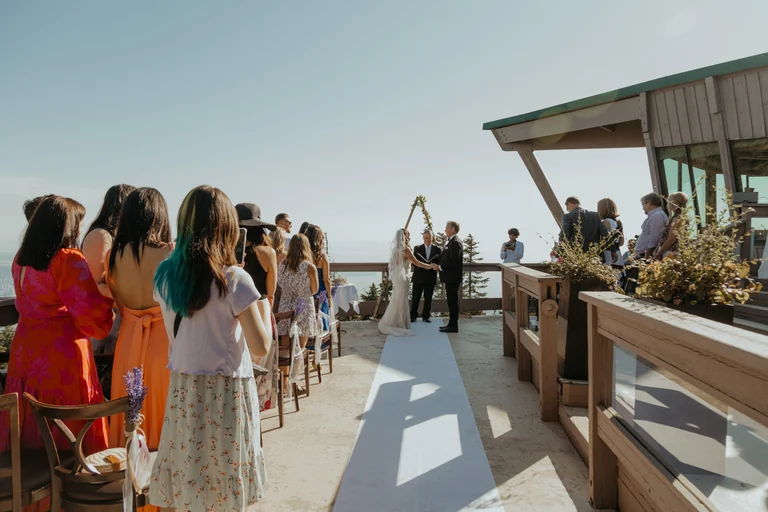 Bridesmaids walking toward an outdoor wedding ceremony