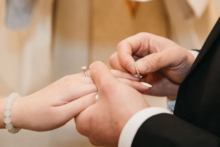 Close-up of a wedding ring exchange