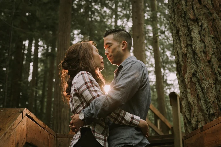 Couple embracing during a woodland engagement session