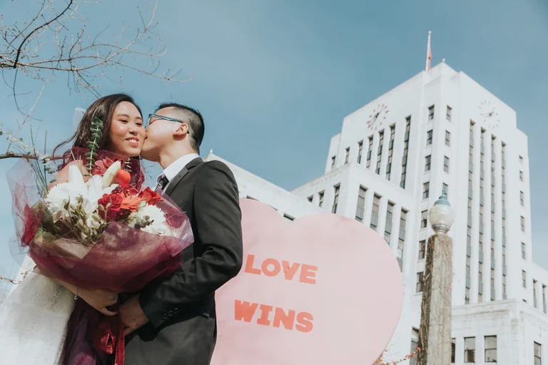 Couple holding a Love Wins sign