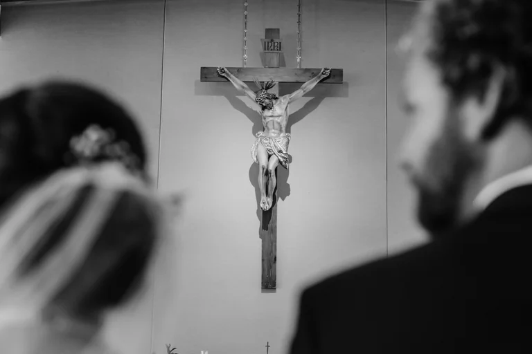 Crucifix overlooking a church wedding ceremony
