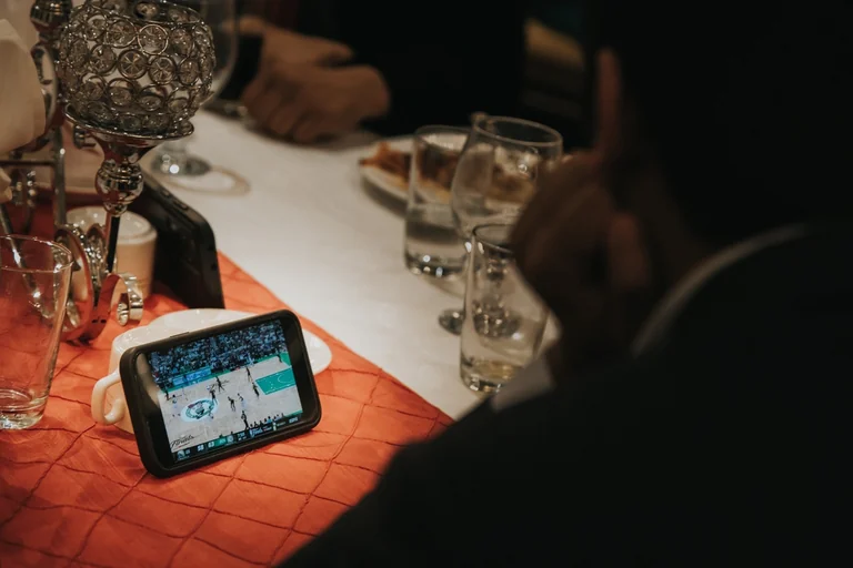 Family watching a wedding video on a tablet