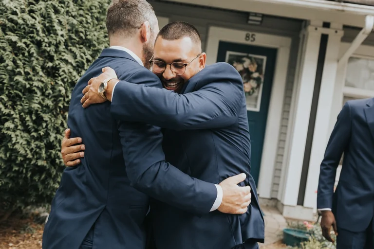 Groom embracing a friend before the ceremony