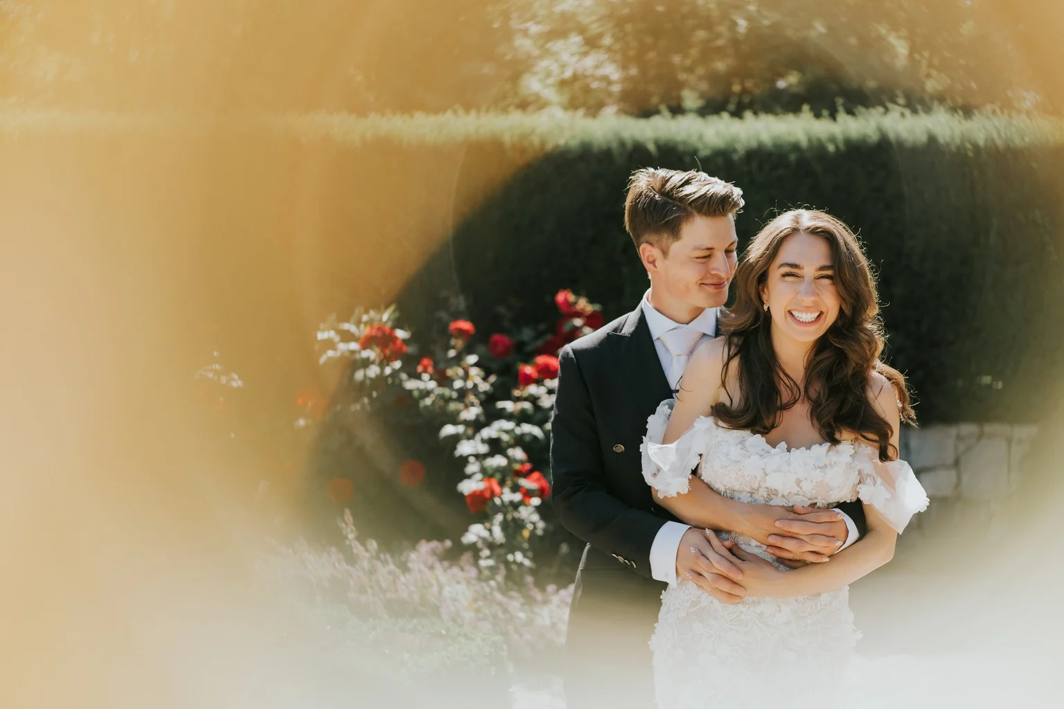 Groom embracing the bride outdoors