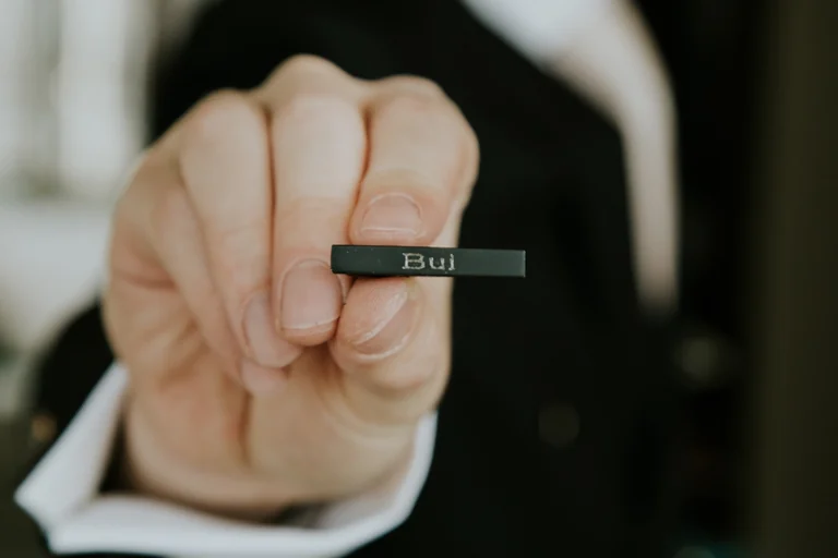 Groom holding an engraved wedding ring
