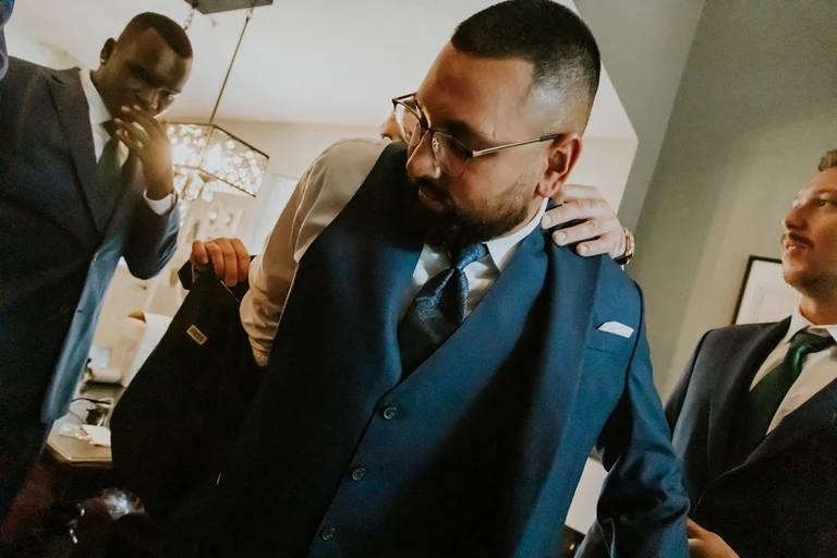 Groom hugging his friends before the ceremony