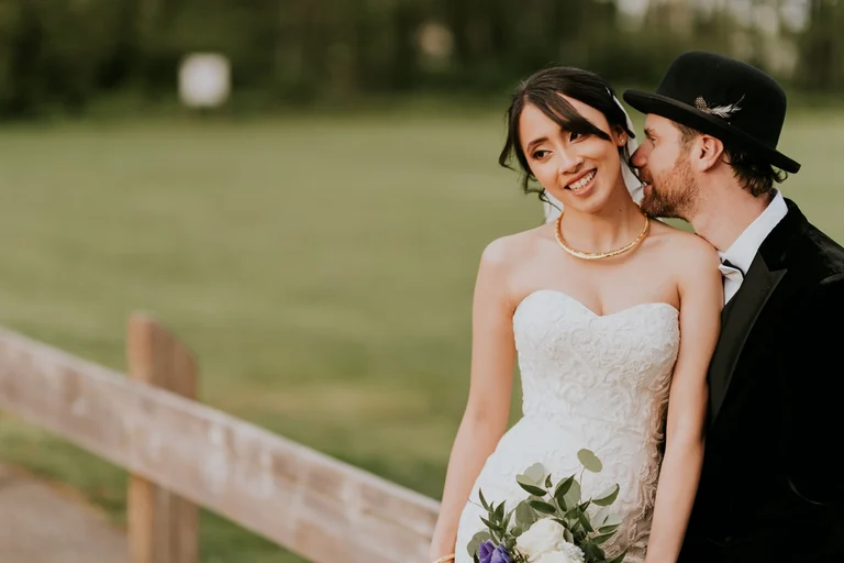 Groom kissing the bride on her cheek