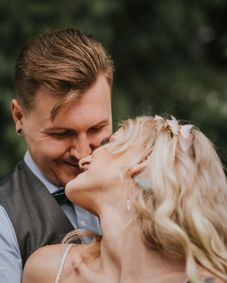 Groom kissing the smiling bride