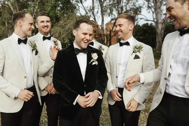 Groom laughing with his groomsmen