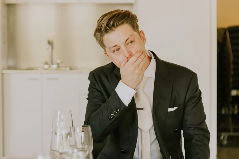 Groom wiping tears at the reception