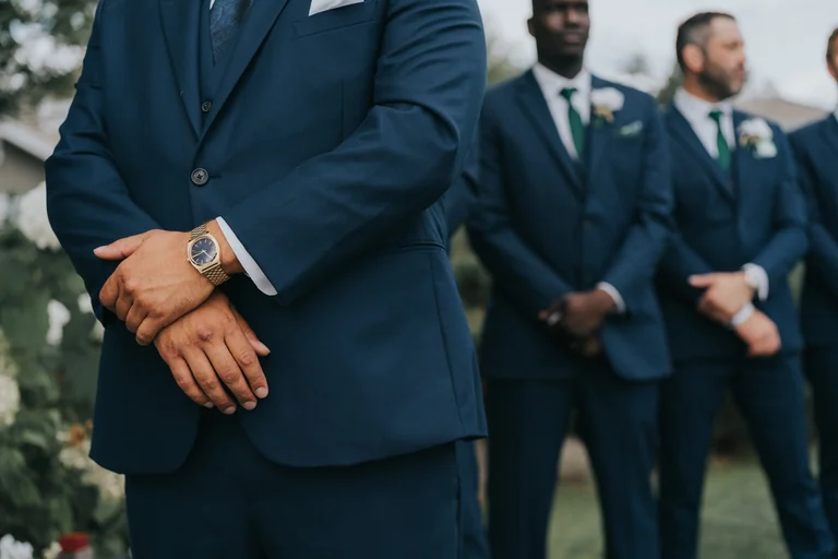 Groomsmen wearing blue suits and white boutonnieres