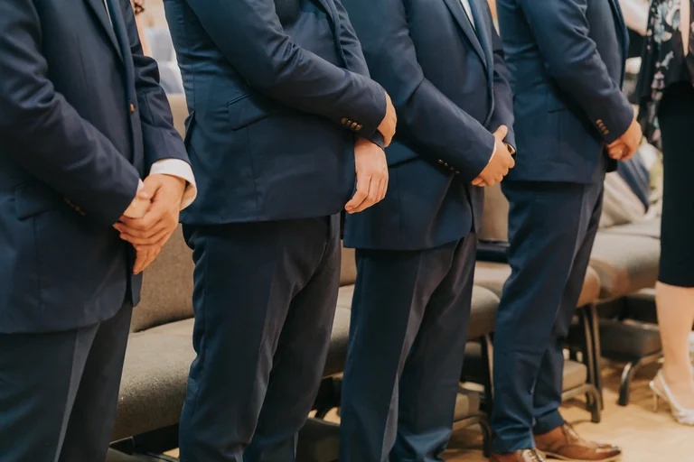 Groomsmen wearing matching blue suits