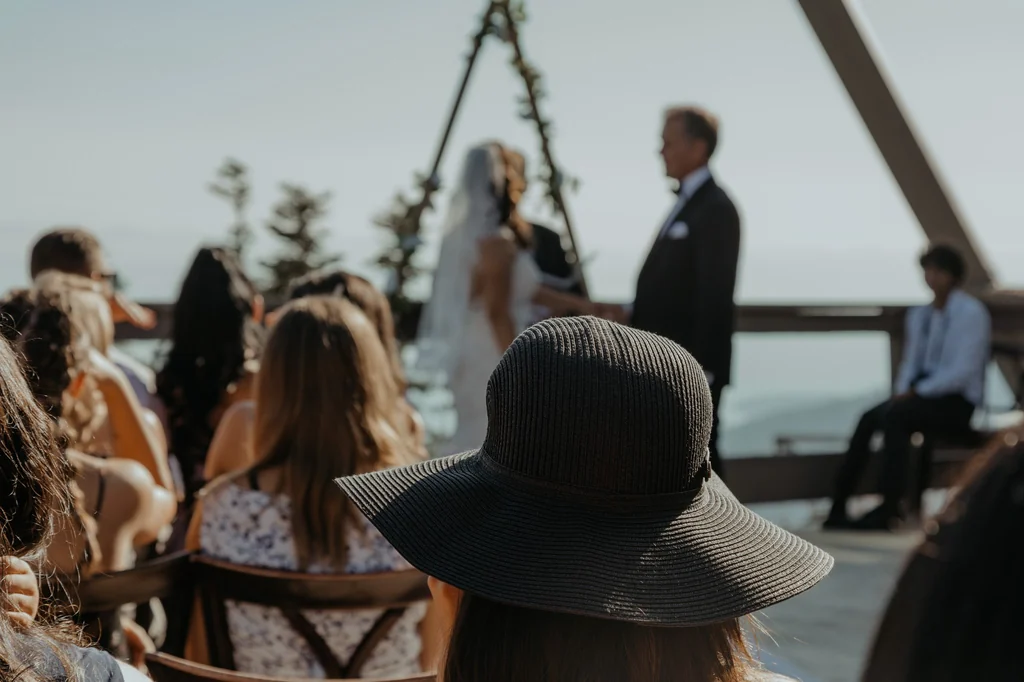 Guest photographing the outdoor wedding ceremony