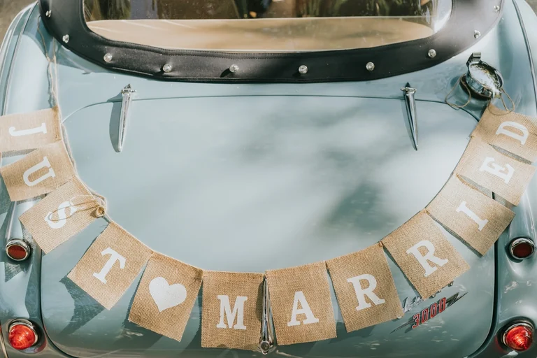 Just Married banner on a vintage wedding car