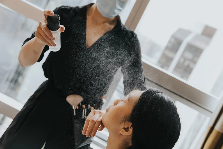 Makeup artist applying the bride's makeup